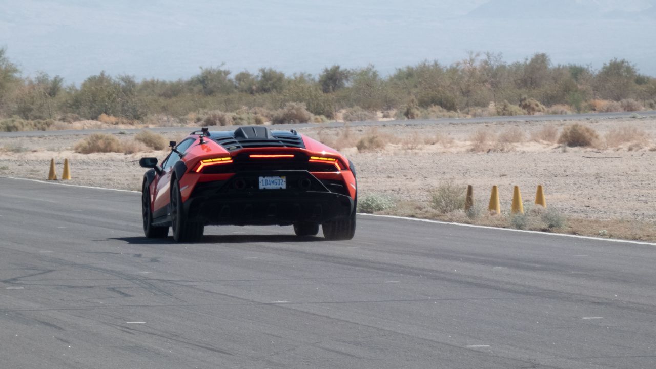 A Lamborghini Haracán Sterrato with cameras attached drives on the track at Chuckwalla Valley Raceway in Desert Center, California