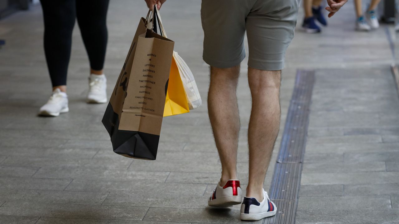 A shopper carries retail bags in Miami, Florida, on Wednesday, June 14, 2023.