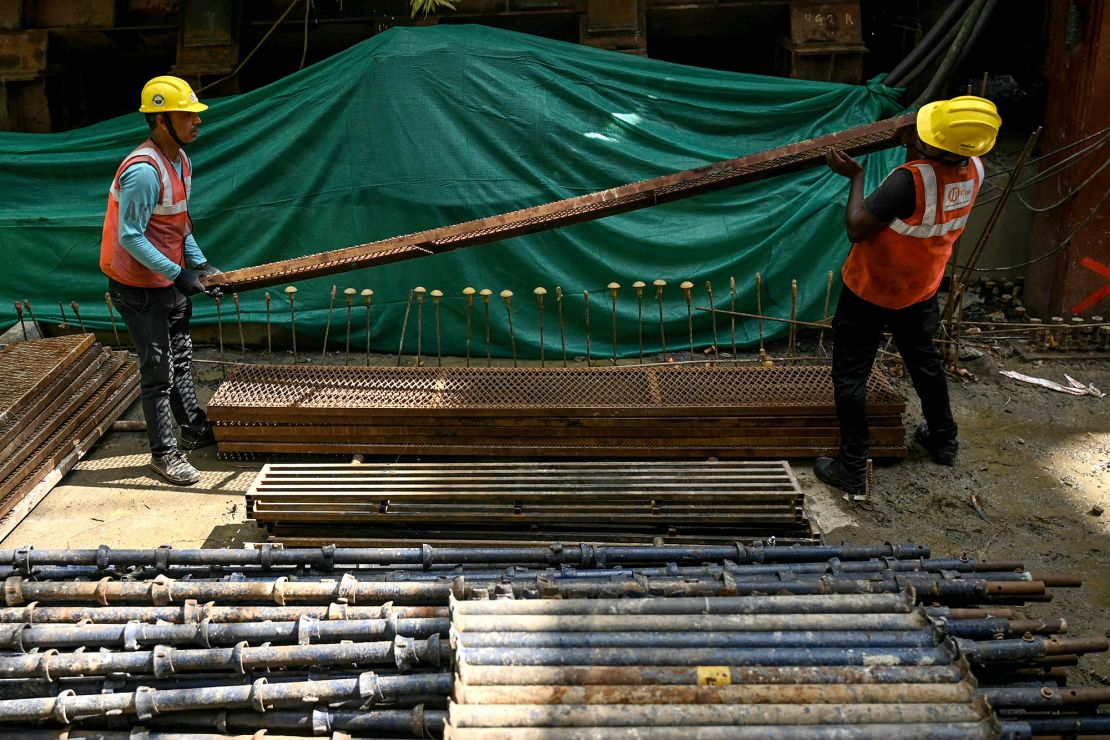 Workers laboring at the 'Chennai Metro Rail project' construction site in the city of Chennai.